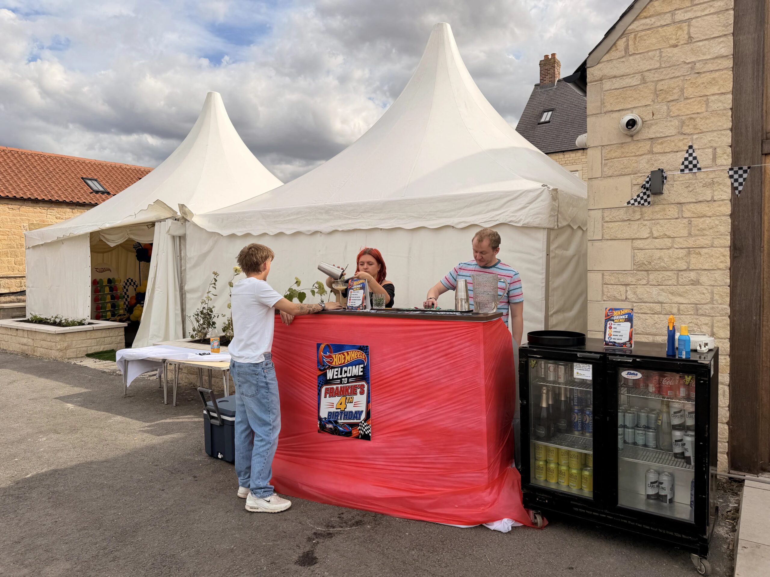A photo of the bamboo door on the road bar staff mixing up tiki cocktails at a mobile bar in sheffield hired for a party